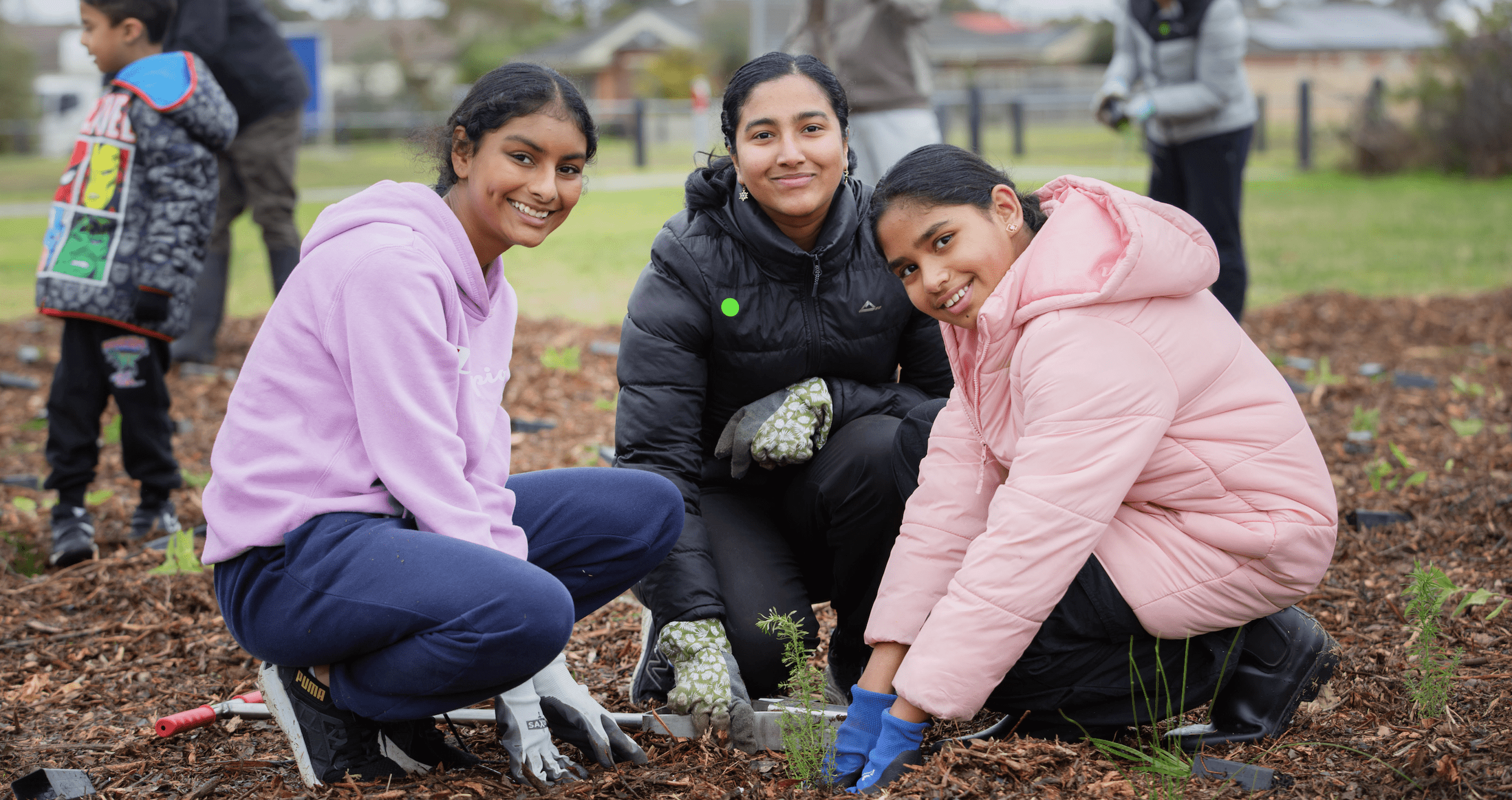 People digging in garden
