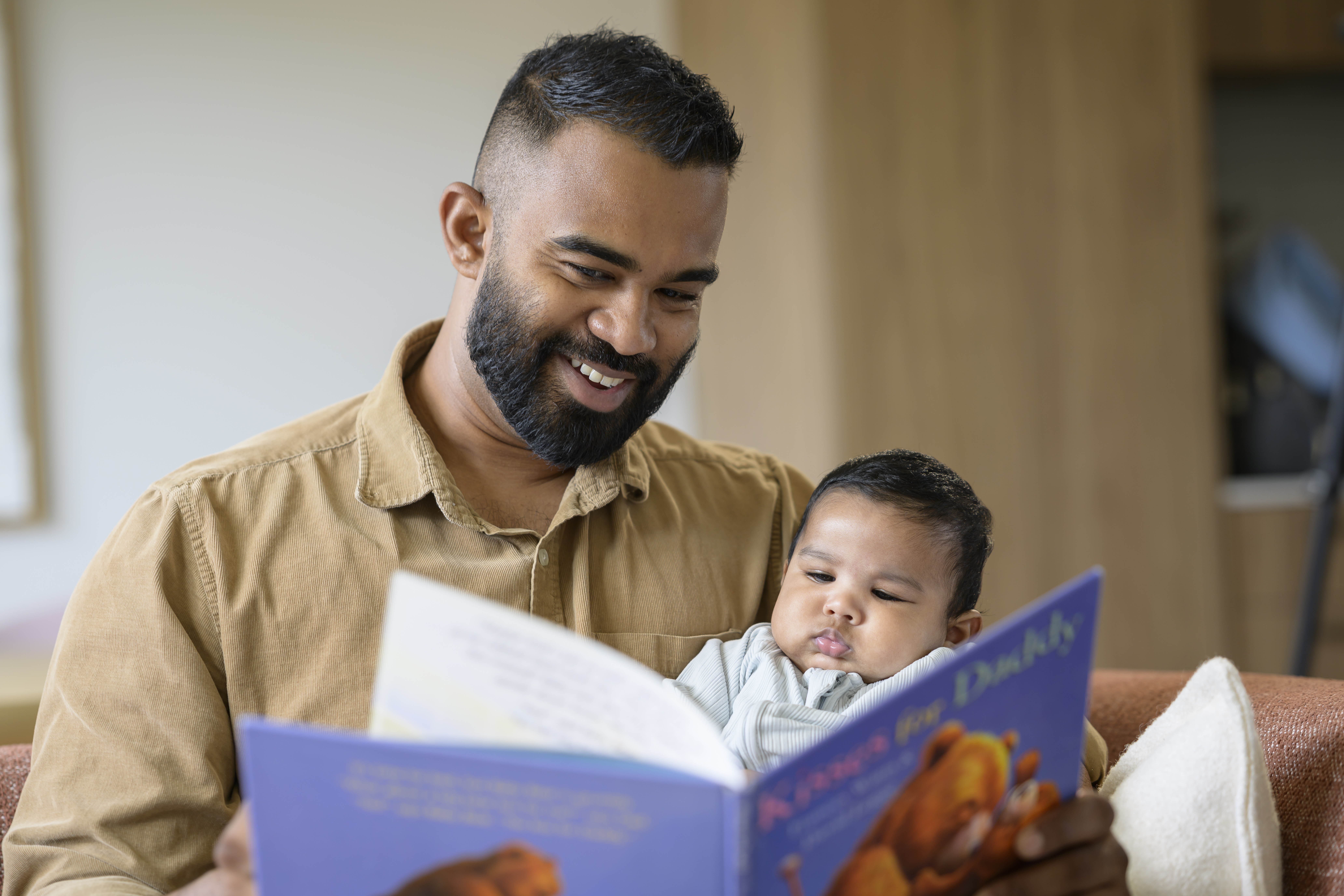 Father reading to his baby