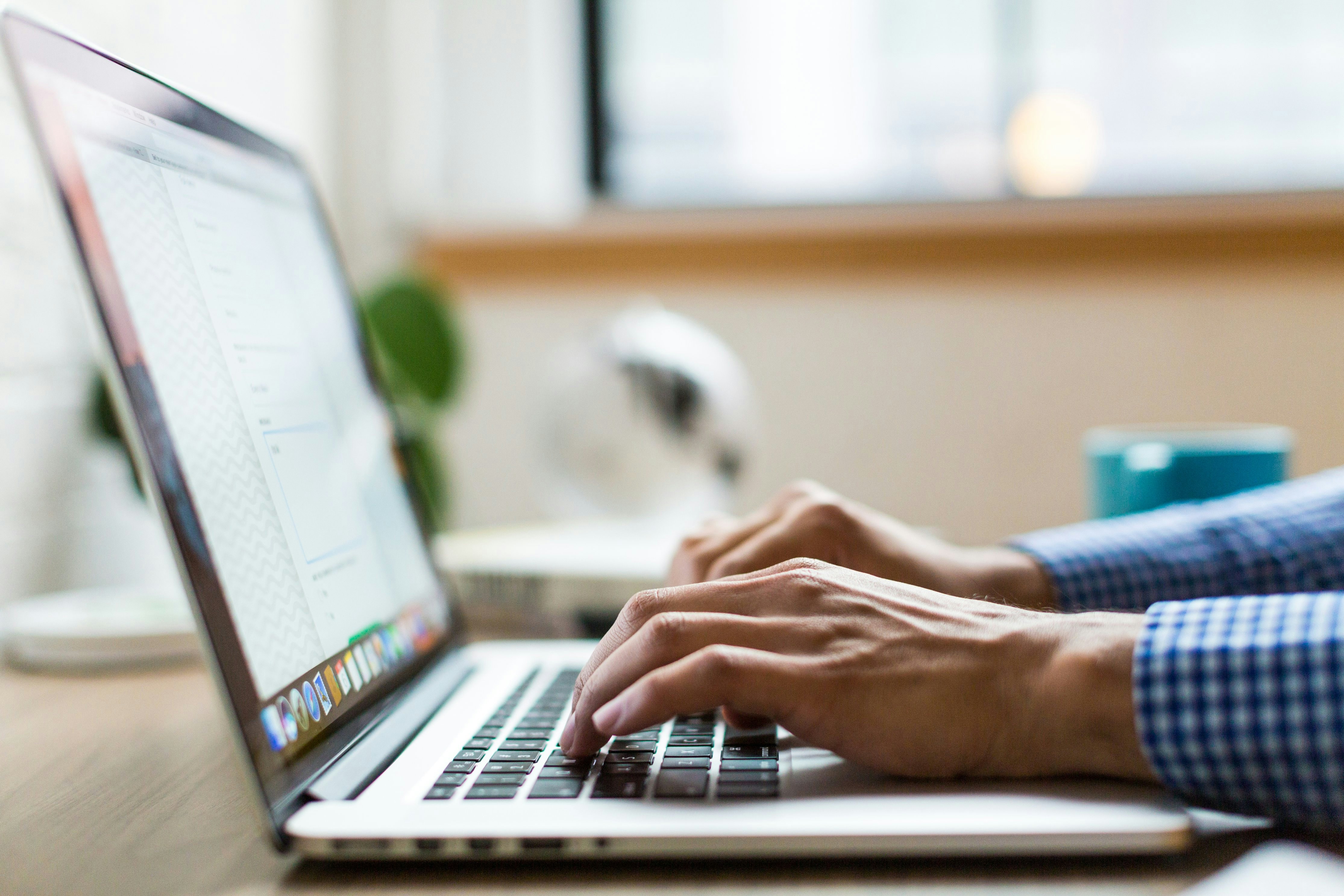 Photo of laptop with someone working on it