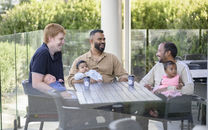 Group of Dad's with their kids around a table