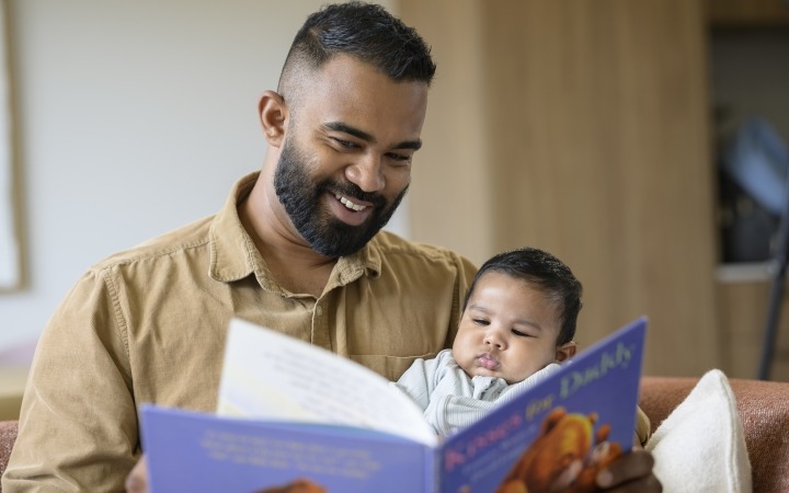 Father reading to his baby