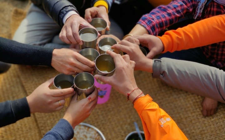 coffee and tea hands together