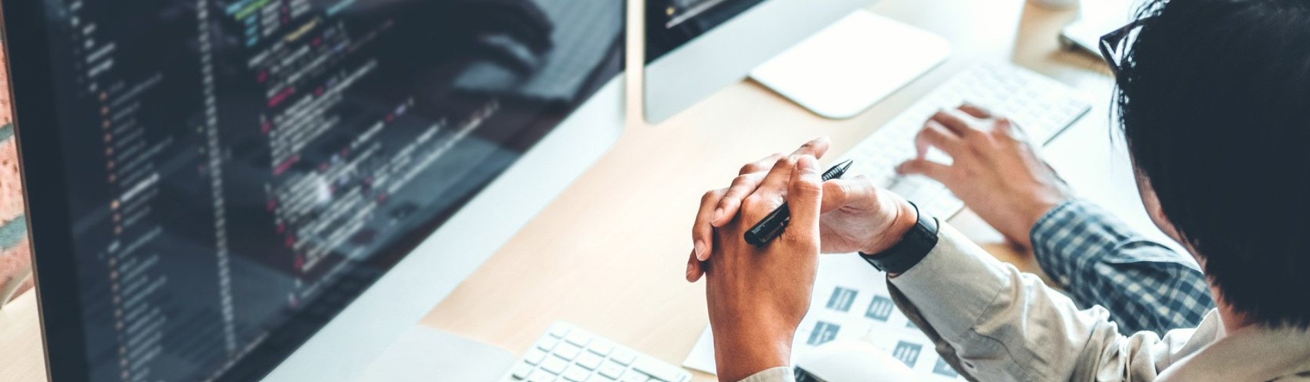 person with hands clasped in front of screen